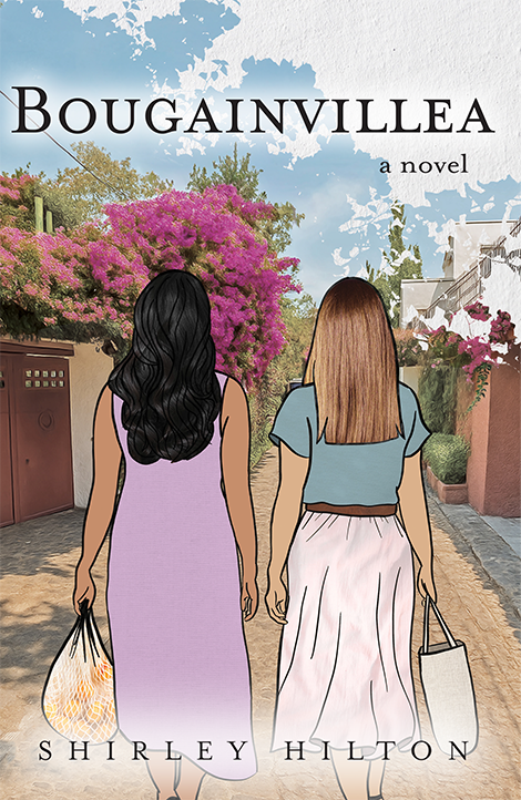 Two women walking toward a bougainvillea bush